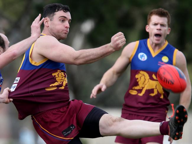 NFL footy: South Morang V Reservoir. at Epping South Morang 35 luke Shelton kicks a goal with 30 for Reservoir Lee Grattidge hanging on Picture: Mark Wilson