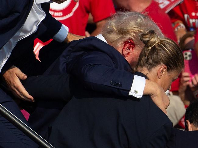 Donald Trump is seen with blood on his ear after being shot. Picture: Rebecca Droke/AFP