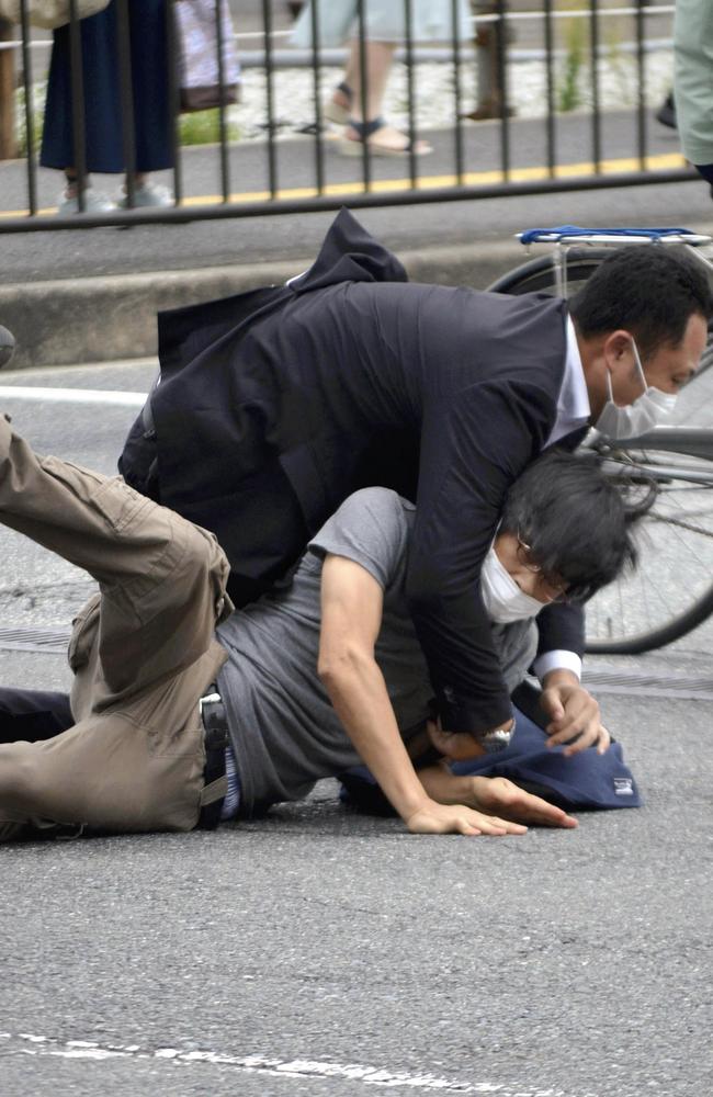 A man, believed to be a suspect in the shooting of former Japanese Prime Minister Shinzo, is tackled to the ground. Picture: AFP