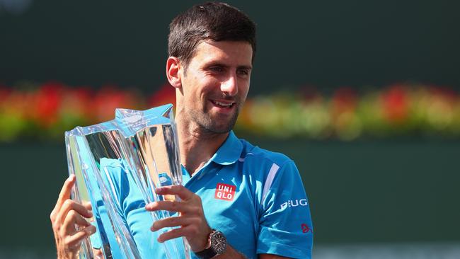 INDIAN WELLS, CA - MARCH 20: Novak Djokovic of Serbia holds up the winners trophy after his win over Milos Raonic of Canada during day fourteen of the BNP Paribas Open at Indian Wells Tennis Garden on March 20, 2016 in Indian Wells, California. Julian Finney/Getty Images/AFP == FOR NEWSPAPERS, INTERNET, TELCOS & TELEVISION USE ONLY ==