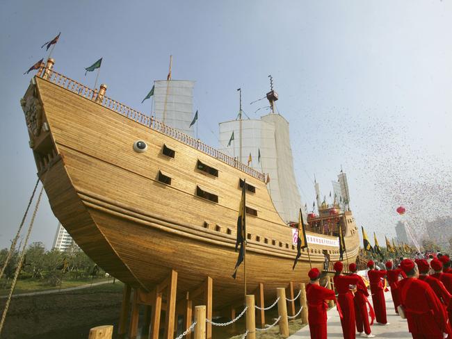 NANJING, CHINA - SEPTEMBER 23: (CHINA OUT) Performers parade in front of the replica of the treasure ship sailed by Chinese navigator Zheng He (1371-1435), at the Zheng He Treasure Boat Factory Ruins Park launching ceremony on September 23, 2006 in Nanjing of Jiangsu Province, China. Zheng led his well-equipped fleets to sail across the Pacific, Indian and Atlantic oceans, reaching more than 30 countries and regions.  (Photo by China Photos/Getty Images)