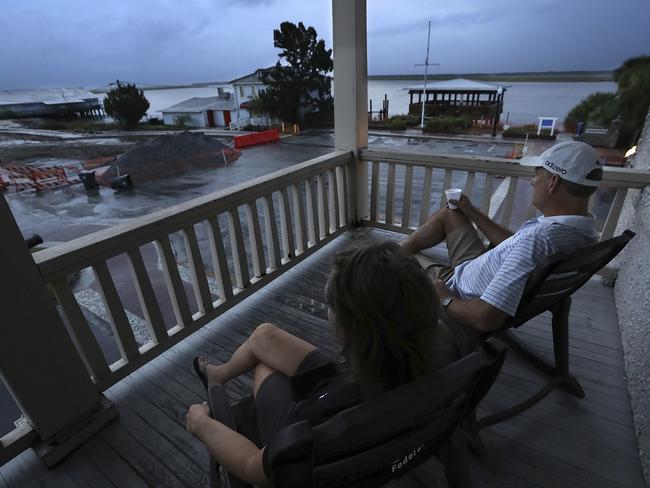 Managers Matt and Janet Kircher, who decided to ride out the storm, watch the approachment of Hurricane Dorian at sunrise from the porch of the Riverview Hotel in St. Mary's, Georgia. Picture: Curtis Compton/Atlanta Journal-Constitution via AP