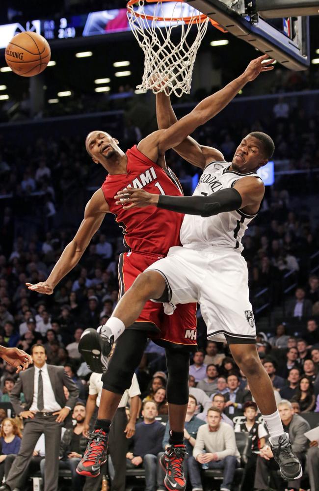 Miami Heat center Chris Bosh (1) defends Brooklyn Nets forward Joe Johnson.