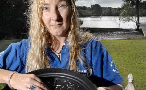 Kathrina Southwell, of Australian Seabird Rescue, sifts through the alarming amount of small plastic strips scooped up when they trawled a small section of the Richmond River at Ballina last week. . Picture: Jay Cronan