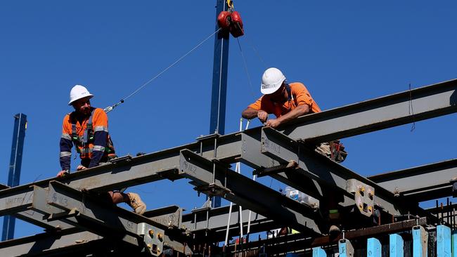 Workers labour on steel beams at a Hutchinson building site. Picture: Brendon Thorne/Bloomberg via Getty Images Sydney construction