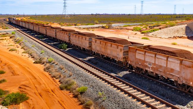 A freight train carrying iron ore heads to Port Hedland. The price of the metal has fallen to two-year lows. Picture: Getty Images