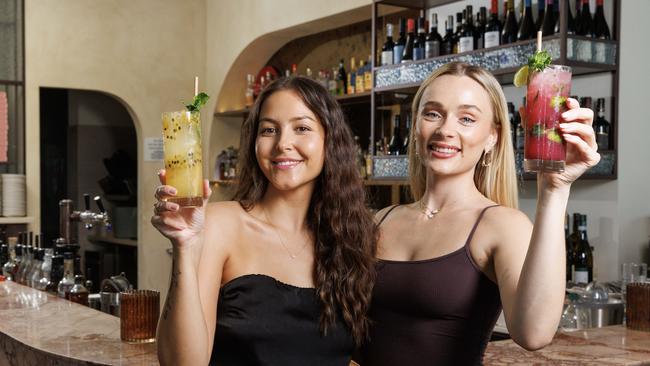 WEEKEND PAPERS ONLY -  Montana-Rose Lamb 25 with a Passionfruit Limonata, and Darcy Moore 26 with a Blueberry Nojito, enjoying Mocktails at Sasso Italiano in Woollongabba. Picture Lachie Millard