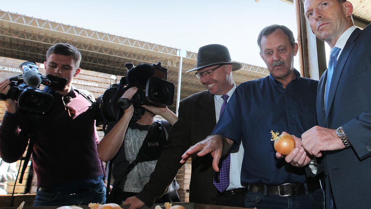 Tony Abbott with Charlton Farm Produce director David Addison seconds before he made the onion in his hand Australia’s most famous vegetable. 