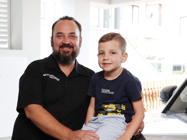 DAILY TELEGRAPH 12TH DECEMBER 2023Pictured at their home in North Kellyville is Luke Spicer and his son Elijah.Luke has installed solar and uses Tesla batteries to power his home.Picture: Richard Dobson