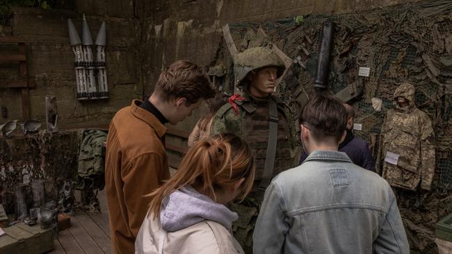 Visitors look at the military uniform of a dead Russian soldier at an outdoor exhibition of items of the Russian army in Kyiv, Ukraine. Picture: Getty