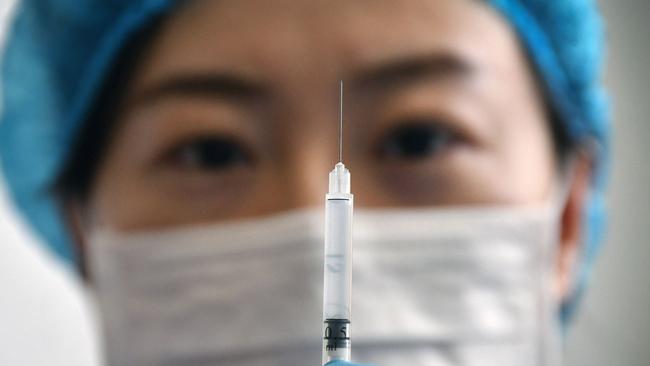 A medical worker displaying a syringe with the Sinovac Biotech vaccine against the COVID-19 coronavirus at a healthcare centre in Yantai in eastern China's Shandong province. (Photo by STR / AFP) / China OUT