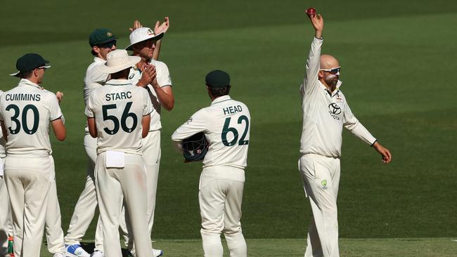 Lyon lifts the ball in the air after taking the milestone wicket. Picture: Getty Images