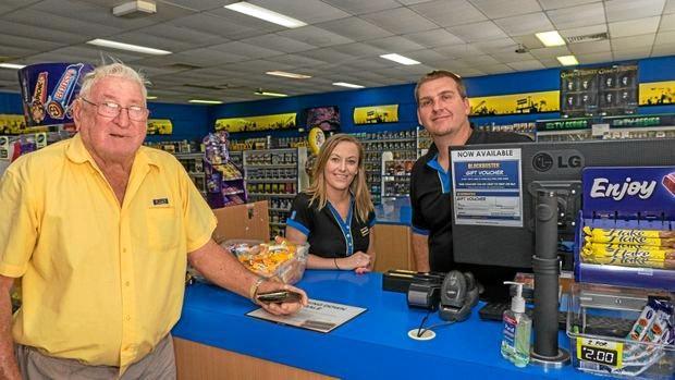 Loyal customer George Smith rents DVDs for the last time from Blockbuster Gympie staff members Jess Westlake and David Kendall. Picture: Jacob Carson