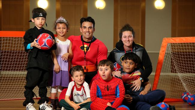 Soccajoeys Next Step trainers Jose Bello and Lauren Phelps with some of the Next Step participants at Baulkham Hills. Pictures: Richard Dobson