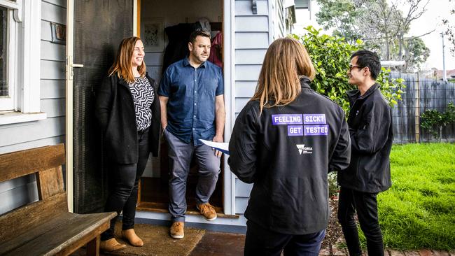 COVID officers Joey Nguyen, right, and Sonia O’Neill go door-to-door in hotspot suburbs to check in with residents, such as Sasha and Stephen Torsi. Picture- Nicole Cleary