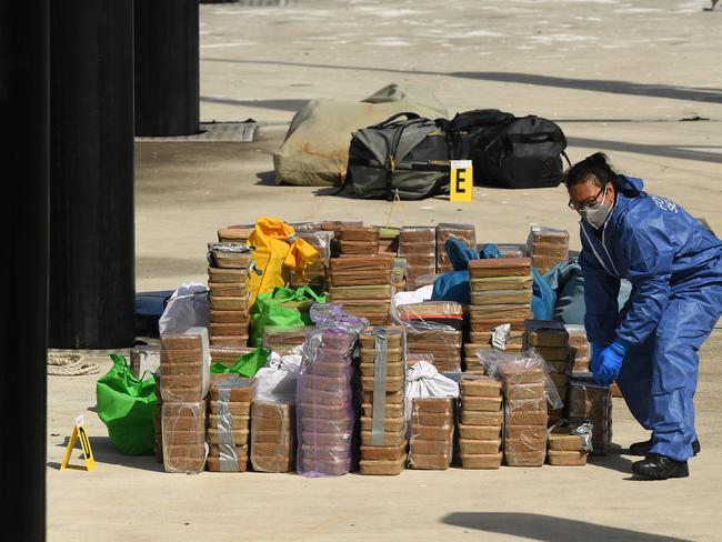 Officers remove the meth from the yacht. Picture: AAP