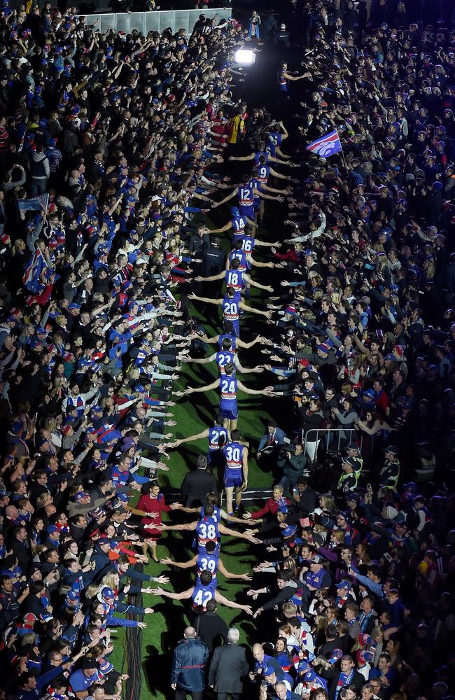 Western Bulldogs players head back on to the MCG to celebrate with fans. Picture: Nicole Garmston