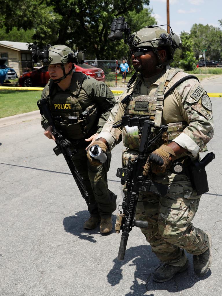 Law enforcement personnel run near the scene of the active shooting. Picture: Reuters/Marco Bello