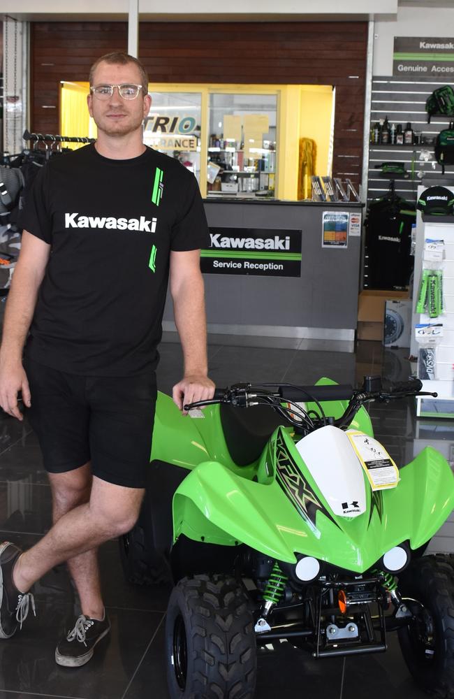 Gympie motorbikes salesman Zhane Bernardin with one of the only quad bikes left in the dealership, designed for children.