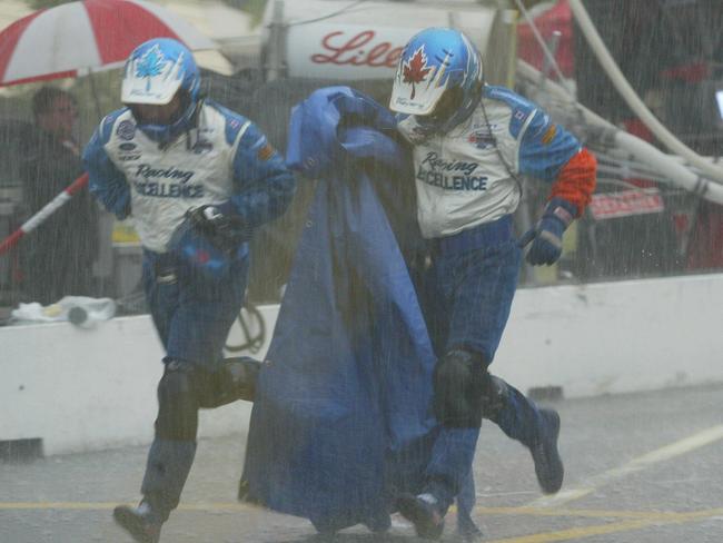 Gold Coast Indy: Paul Tracy pit crew runs for cover as hail storm hits.