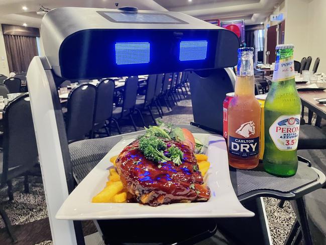 The robot waiter "Beepbop" can sing "Happy Birthday" to guests and the robot can sense its surroundings, preventing it from running into a person. Picture: Jack Colantuono