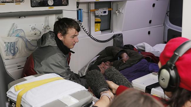 Stephen Ward and his father, John, in the stretcher in the ambulance after being rescued. Picture: MATHEW FARRELL