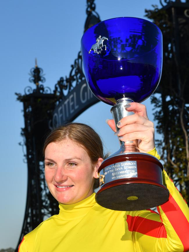 Jamie Kah poses with the trophy after winning the Makybe Diva Stakes at Flemington. Picture: AAP