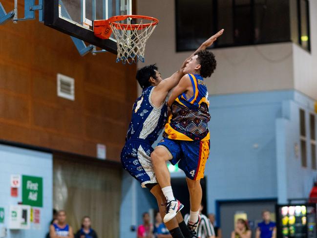 William Burton is fouled heavily by Henry Bui on a drive to the basket. Picture: Che Chorley