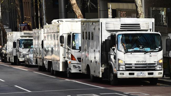 Prison vans queue outside the court. Picture: Jake Nowakowski