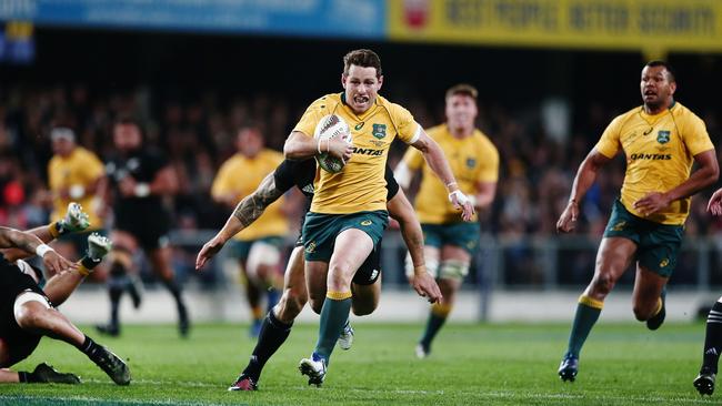 Bernard Foley makes a break on his way to score a try. Picture: Getty