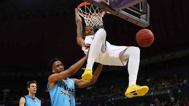 Sydney Kings’ Greg Whittington hangs on the hoop after a big dunk against the Breakers yesterday. Picture: Brett Costello