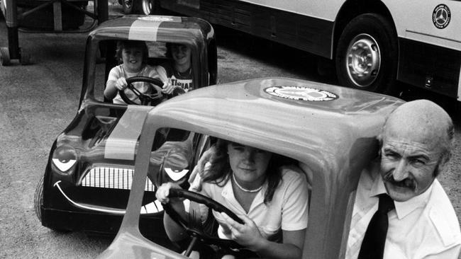 At the Goulburn Valley Driver Training Complex in 1981, young trainee drivers Simon Montgomery, 11, and Tracey Bush, 13, share one of the "Careful Cobber" cars while Melissa Montgomery, 13, makes room for her father Eric, the director of the complex. Picture: Supplied