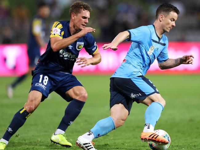 Sydney FC’s Alex Baumjohann takes the ball past the Mariners’ Gianni Stensness. Picture: Getty Images