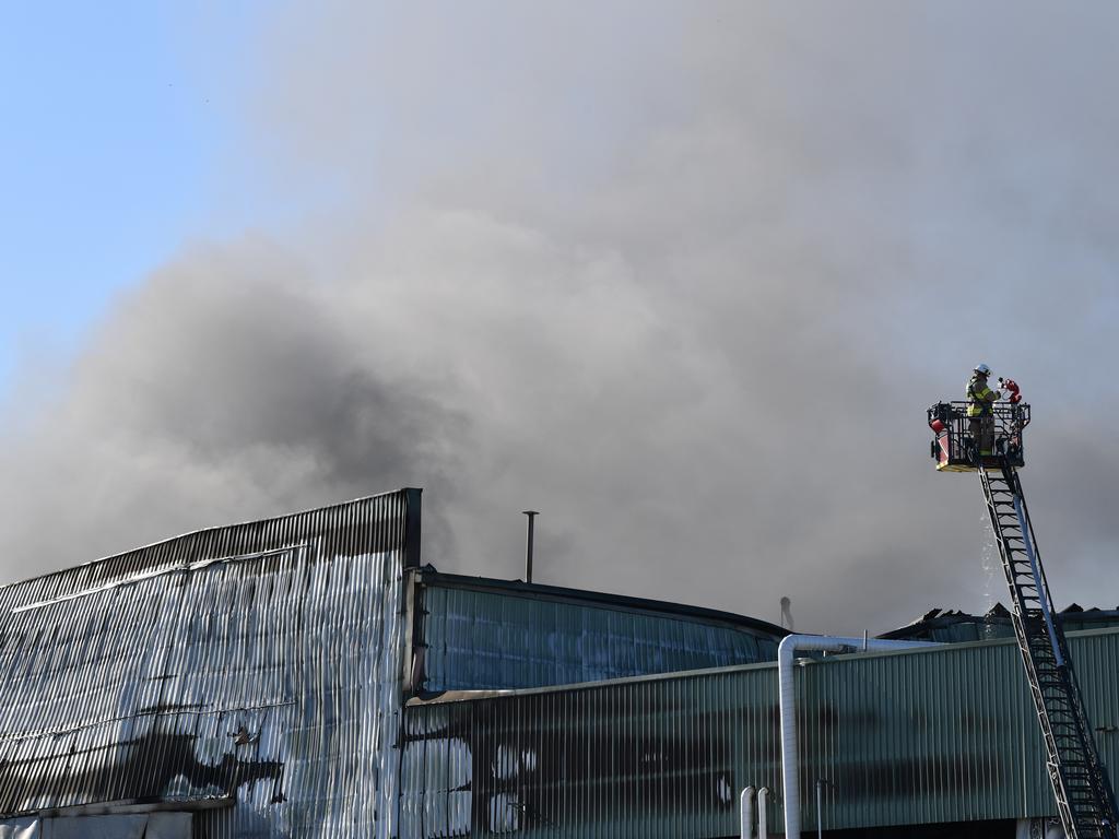 Emergency services continue to work on the huge fire at the Thomas Foods abattoir in Murray Bridge the morning after it broke out. Picture: AAP / Roy Vandervegt