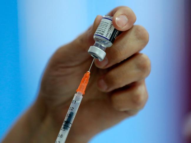 A health worker prepares a dose of the Pfizer-BioNTech vaccine against coronavirus. A Swiss study shows the vaccine works. Picture: AFP