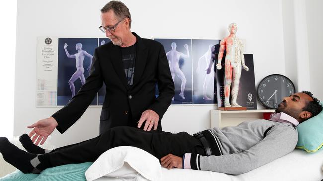 Mr Farrow in his Balmain studio treating a patient. Picture: Jonathan Ng