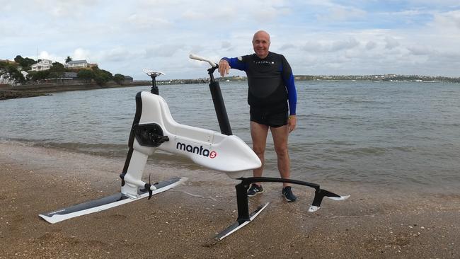 Chris Griffith test rides the Hydrofoiler XE-1 by Manta5, an electric bike that planes across water, at Devonport beach in Auckland, New Zealand in 2020.