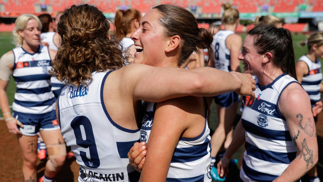 Nina Morrison embraces debutant Caitlin Thorne as the Cats celebrate their first win of the season. Picture: Russell Freeman/AFL Photos via Getty Images