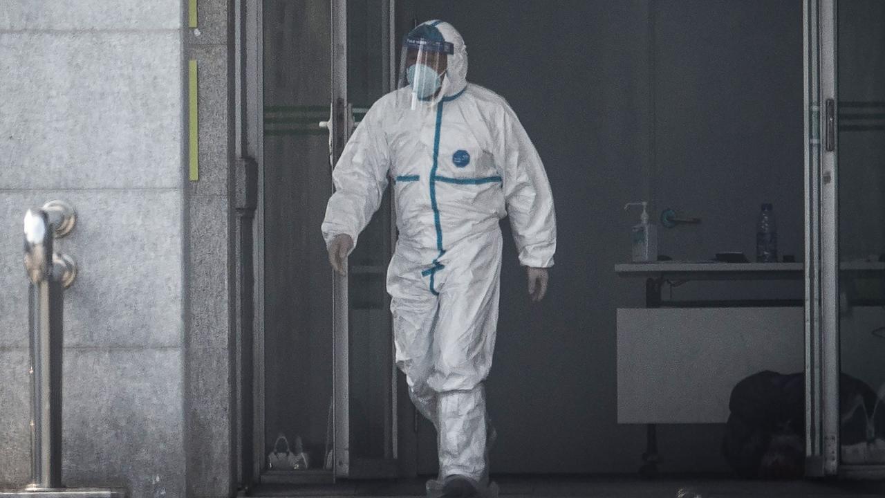 A medical staff member walks outside the Jinyintan hospital, where patients are being treated. Picture: STR/AFP