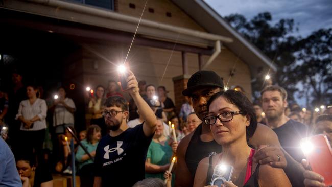 The solemn gathering lit up the dusk. Picture: Jeremy Piper