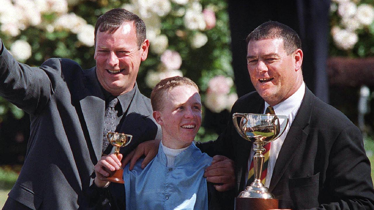 Mike Moroney (left) celebrating his 2000 Melbourne Cup win with Brew alongside jockey Kerrin McEvoy (centre) and his brother Paul (right), who also part-owned the stayer.