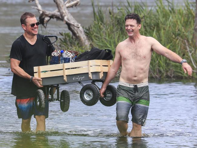 Hollywood actor Matt Damon with a pal moving a trolley of items. Picture: MEDIA MODE/BACKGRID