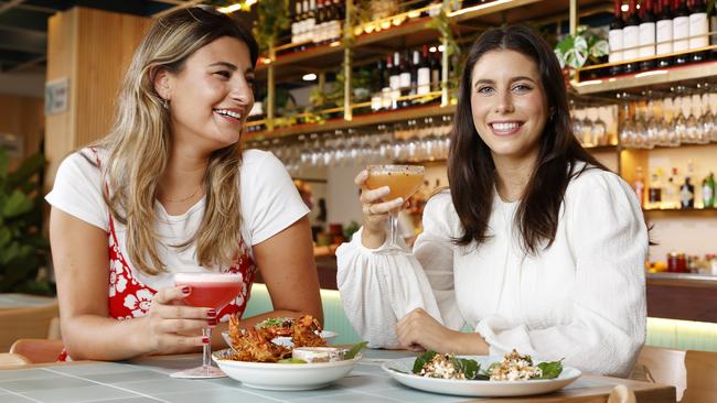 Alexandria Thomas, 23, (left) with Ella Schamschula, 22, at the Little Pearl Bar, in Manly, which would be able to stay open later at night if the area became a designated ”Special Entertainment Precinct”. Picture: Jonathan Ng