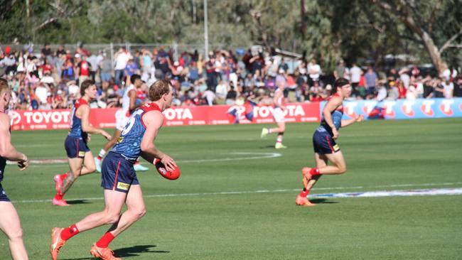 Melbourne Demons player Tom McDonald drives it long down the line. Picture: Gera Kazakov
