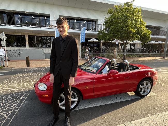 Aidan Croft arrived in a red Mazda MX5 convertible.