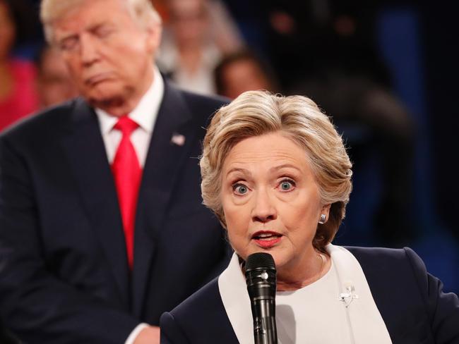 (FILES) This file photo taken on October 9, 2016 shows Democratic nominee Hillary Clinton (R) and Republican Presidential nominee Donald Trump participate in a town hall debate at Washington University in St. Louis, Missouri.  Donald Trump said on November 9, 2016 he would bind the nation's deep wounds and be a president "for all Americans," as he praised his defeated rival Hillary Clinton for her years of public service. / AFP PHOTO / POOL / RICK WILKING