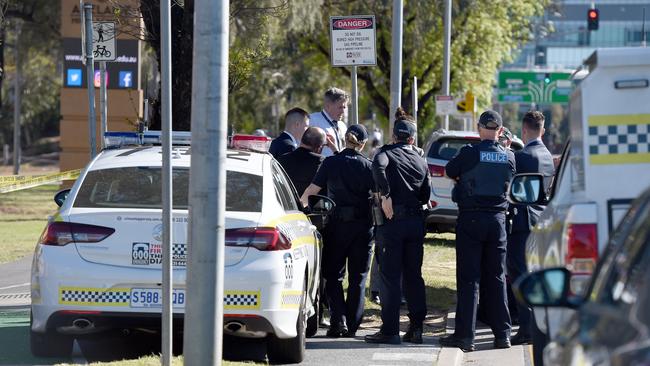 Detectives at the scene of the bashing at Adelaide High School. Picture: Naomi Jellicoe