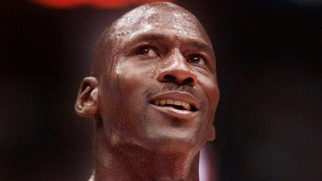 Michael Jordan looks up at the scoreboard as the Bulls close in on their second three-peat in 1998.