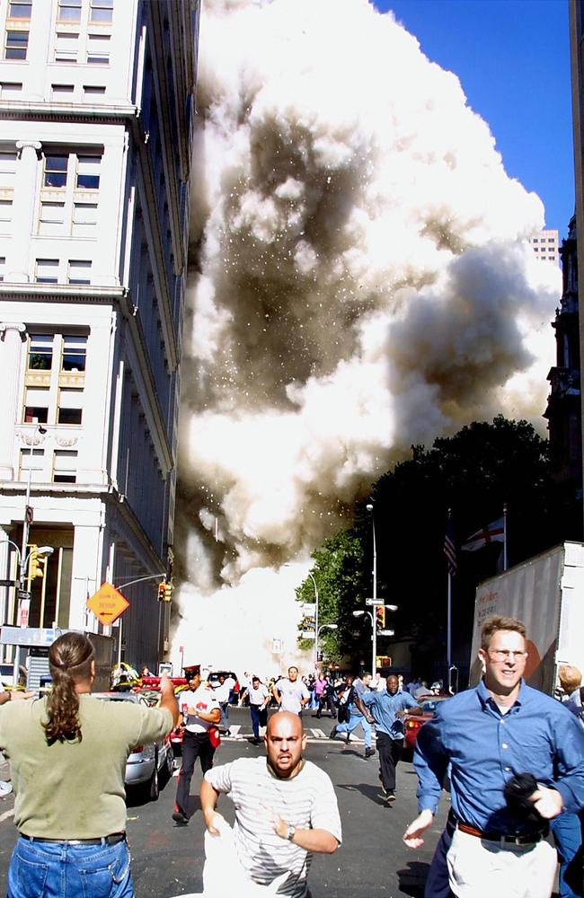 Pedestrians run from the scene as one of the World Trade Centre towers collapses in this September 11, 2001 file photo. Picture: Doug Kanter/AFP