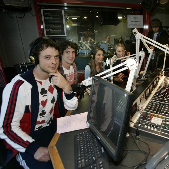 Radio hosts Hamish Blake and Andy Lee film a scene for TV show Neighbours at Fox FM Studios, St Kilda. (L to R) Hamish Blake, Andy Lee, Caitlin Stasey (Neighbours actor), Margot Robbie (Neighbours actor) and Nick Anderson.